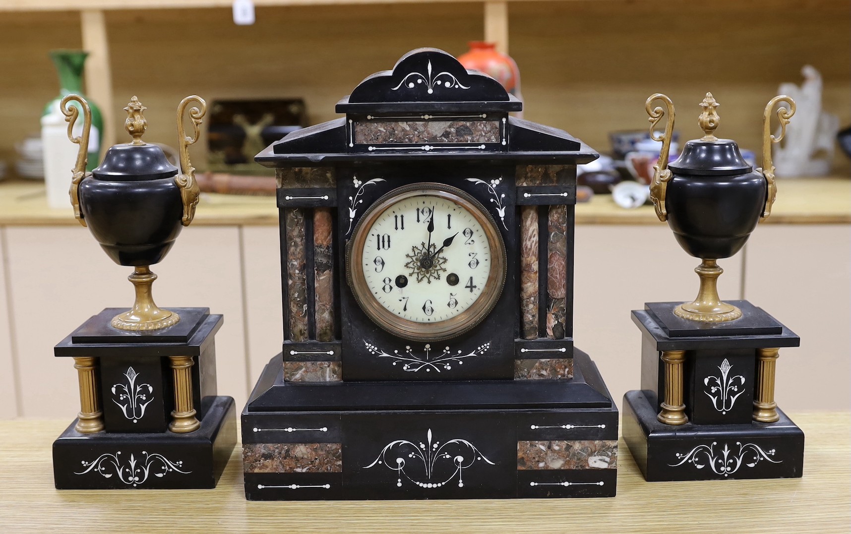 A black slate and marble clock garniture, clock 33cms high